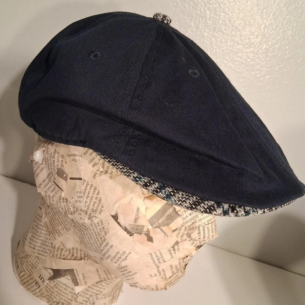 Mens Navy blue flat cap with white penguin logo plaid detail under brim